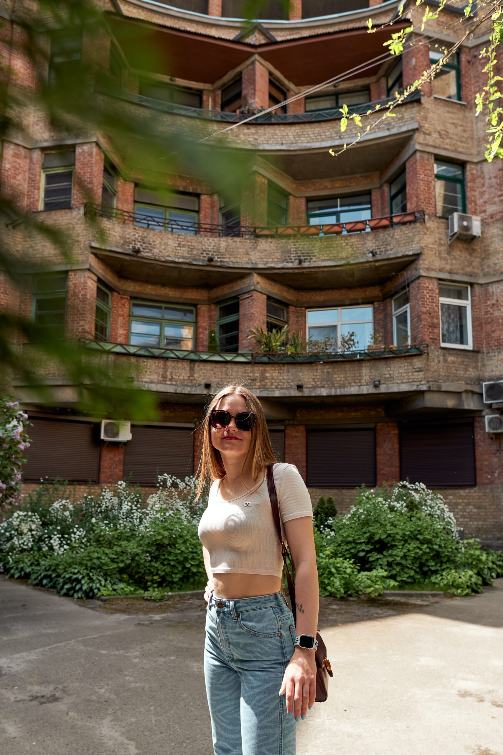 a woman standing on a skateboard in front of a building